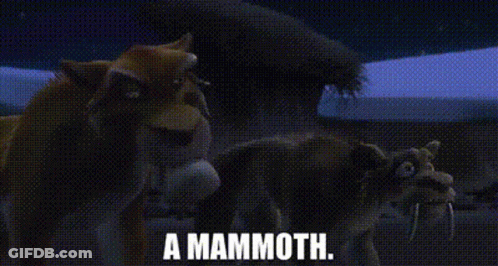 A Group Of Animals Standing Next To Each Other In A Field With The Words `` A Mammoth '' Written On It . GIF