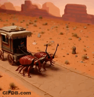 A Group Of Ants Are Pulling A Wagon In The Desert GIF
