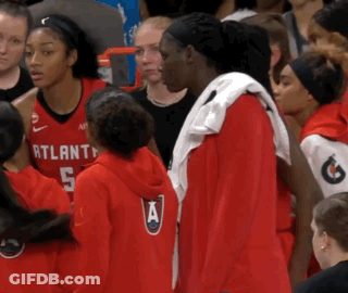 A Group Of Atlanta Basketball Players Are Standing In A Crowd GIF