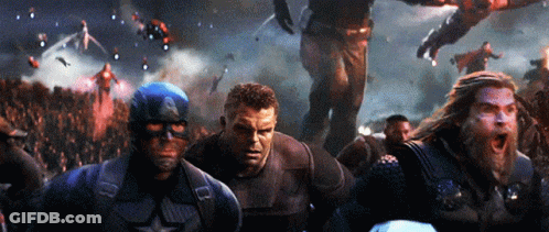 A Group Of Avengers Including Captain America Thor And Hulk Are Standing In Front Of A Crowd GIF