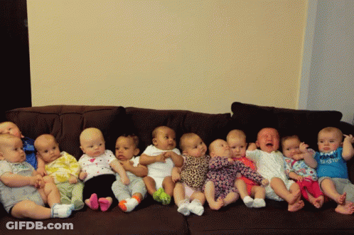 A Group Of Babies Are Sitting On A Couch And One Of Them Is Wearing A Shirt That Says Daddy GIF