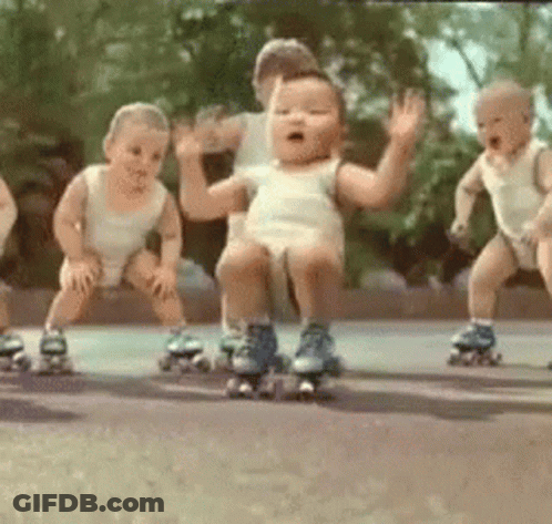 A Group Of Babies Wearing Roller Skates Are Dancing Together . GIF