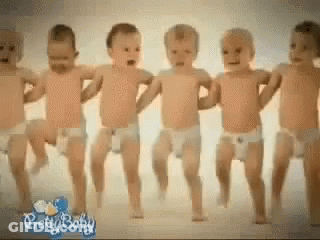 A Group Of Baby 'S In Diapers Are Dancing Together GIF