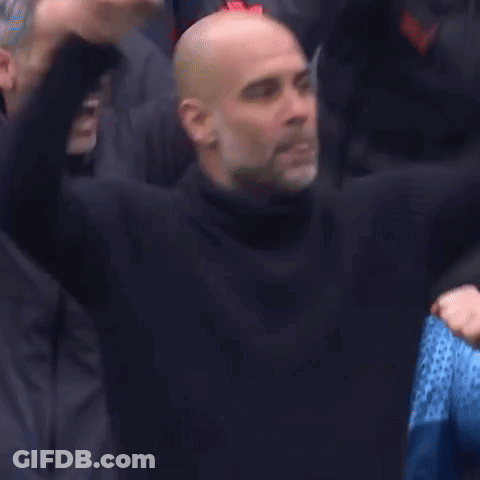A Group Of Bald Men Are Sitting In A Stadium With Their Hands In The Air . GIF