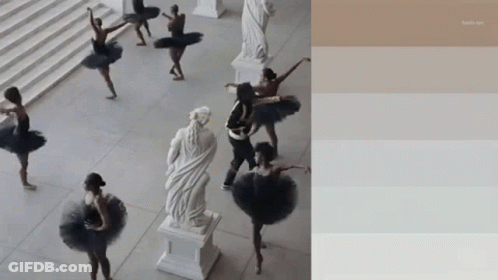 A Group Of Ballerinas Are Dancing In Front Of A Statue Of A Woman GIF