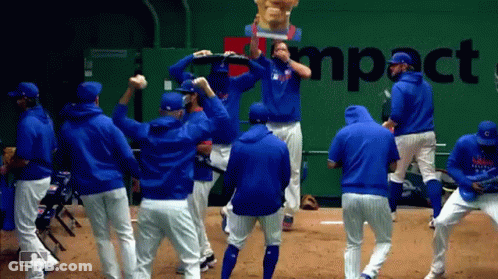 A Group Of Baseball Players Are Dancing In Front Of A Wall That Says Impact GIF