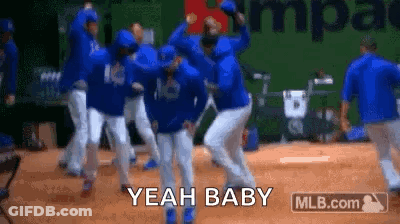 A Group Of Baseball Players Are Dancing On A Field And They Are Saying Yeah Baby . GIF