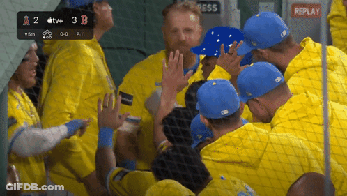 A Group Of Baseball Players Are Huddled Together In A Dugout With Replay Written On The Bottom GIF