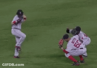 A Group Of Baseball Players Are Playing A Game On A Field . One Of The Players Has The Number 50 On His Jersey . GIF