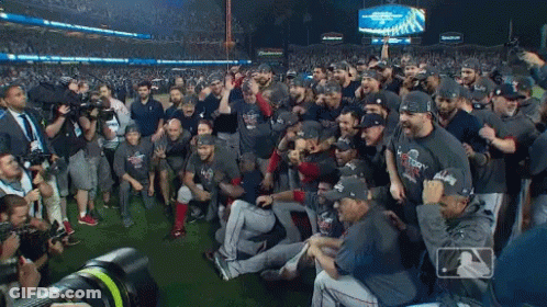 A Group Of Baseball Players Are Posing For A Photo With A Budweiser Sign In The Background GIF