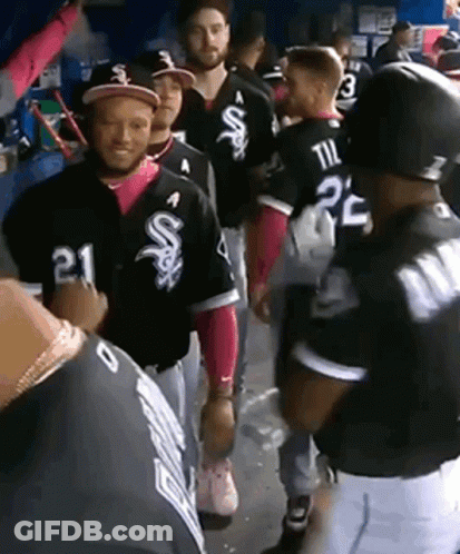 A Group Of Baseball Players Are Standing In A Dugout And One Of Them Has The Number 21 On His Jersey GIF