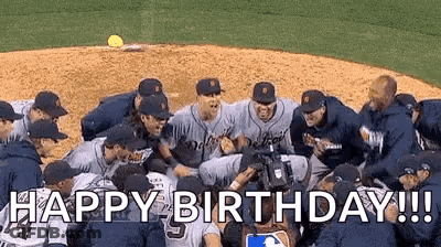 A Group Of Baseball Players Are Standing In A Huddle On A Baseball Field And Celebrating . GIF