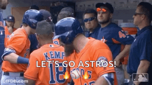 A Group Of Baseball Players Are Standing Next To Each Other In A Dugout And Hugging Each Other . GIF