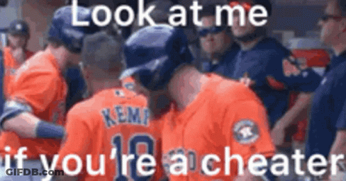A Group Of Baseball Players Are Standing Next To Each Other In A Dugout And Talking To Each Other . GIF