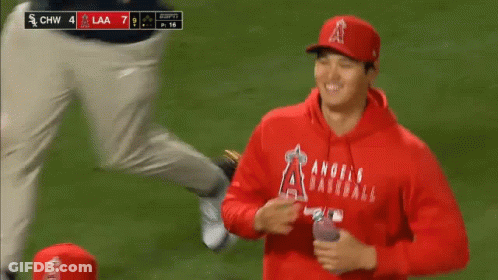 A Group Of Baseball Players Are Standing On A Field During A Game . GIF