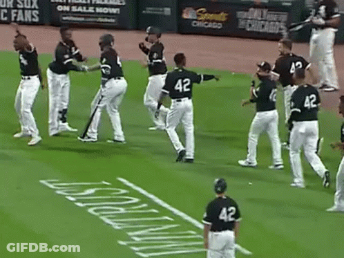 A Group Of Baseball Players Are Standing On A Field Holding Bats . GIF
