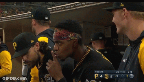 A Group Of Baseball Players In A Dugout With Rogers On The Scoreboard GIF