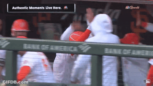 A Group Of Baseball Players In A Dugout With The Words Authentic Moments Live Here GIF