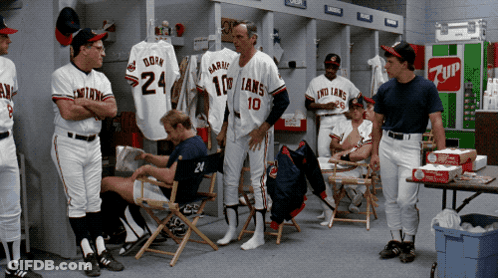 A Group Of Baseball Players In A Locker Room With A 7Up Vending Machine GIF