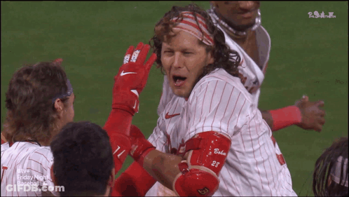 A Group Of Baseball Players With One Wearing A Jersey With The Number 28 On It GIF
