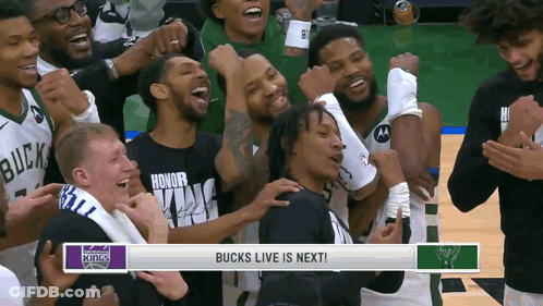 A Group Of Basketball Players Are Celebrating A Victory With A Banner That Says Bucks Live Is Next GIF