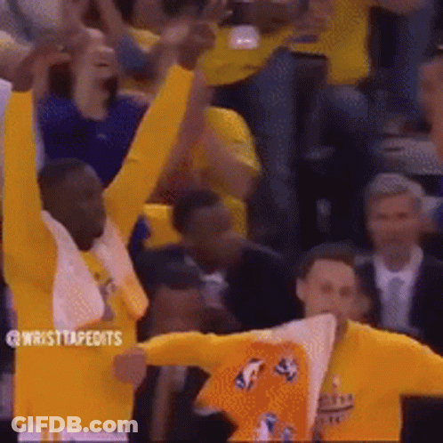 A Group Of Basketball Players Are Celebrating In Front Of A Crowd With Their Arms In The Air . GIF