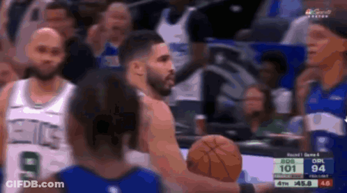 A Group Of Basketball Players Are Playing A Game And One Of Them Is Holding A Basketball . GIF