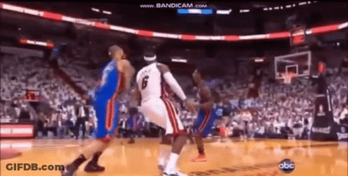 A Group Of Basketball Players Are Playing A Game Of Basketball In A Stadium . GIF