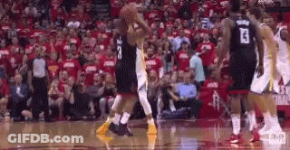 A Group Of Basketball Players Are Playing A Game Of Basketball In Front Of A Crowd . GIF