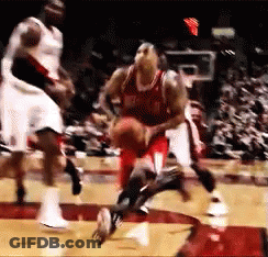 A Group Of Basketball Players Are Playing A Game Of Basketball On A Court GIF