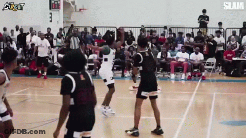 A Group Of Basketball Players Are Playing A Game Of Basketball On A Court . GIF
