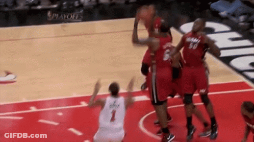 A Group Of Basketball Players Are Playing A Game Of Basketball On A Court . GIF
