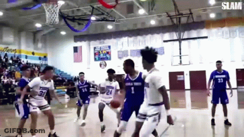 A Group Of Basketball Players Are Playing A Game Of Basketball On A Court . GIF
