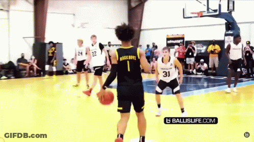 A Group Of Basketball Players Are Playing A Game Of Basketball On A Court . GIF
