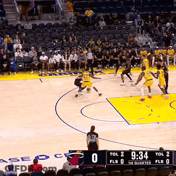 A Group Of Basketball Players Are Playing A Game Of Basketball On A Court With A Crowd Watching . GIF