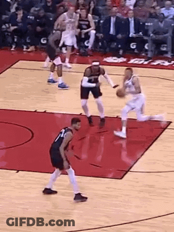 A Group Of Basketball Players Are Playing A Game On A Basketball Court . GIF