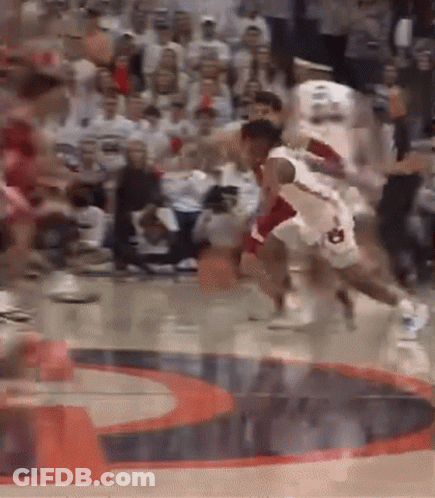 A Group Of Basketball Players Are Playing A Game On A Court . GIF