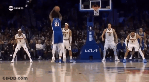 A Group Of Basketball Players Are Playing A Game On A Court . GIF
