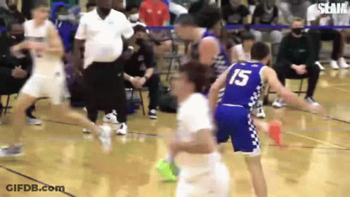 A Group Of Basketball Players Are Playing A Game On A Court . One Of The Players Is Wearing The Number 15 Jersey . GIF