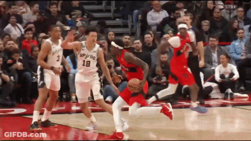 A Group Of Basketball Players Are Playing A Game On A Court . GIF