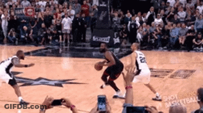 A Group Of Basketball Players Are Playing Basketball On A Court . GIF