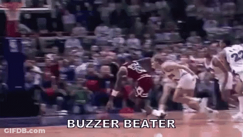 A Group Of Basketball Players Are Playing Basketball On A Court With The Words `` Buzzer Beater '' Written On It . GIF