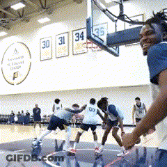 A Group Of Basketball Players Are Playing On A Court With Numbers 30 31 34 And 35 On The Wall Behind Them GIF