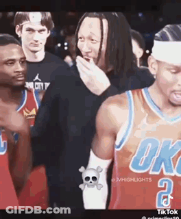 A Group Of Basketball Players Are Standing Next To Each Other And One Of Them Is Covering His Mouth . GIF