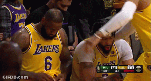 A Group Of Basketball Players Are Standing Next To Each Other In A Basketball Game . GIF