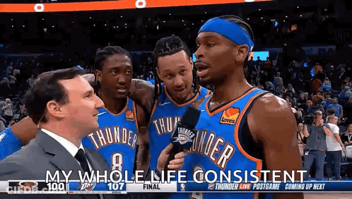 A Group Of Basketball Players Are Standing Next To Each Other On A Court . GIF