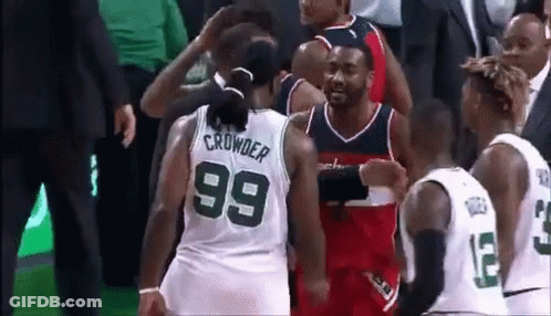 A Group Of Basketball Players Are Standing Next To Each Other On A Court . GIF