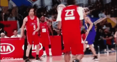 A Group Of Basketball Players Are Standing On A Basketball Court . GIF