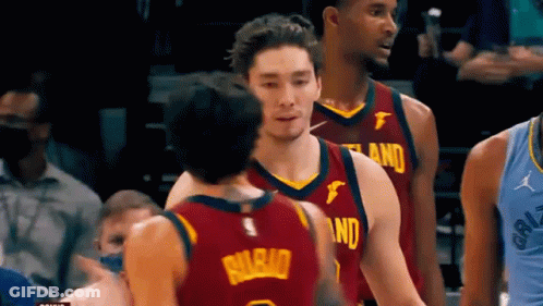 A Group Of Basketball Players Are Standing On A Court . GIF