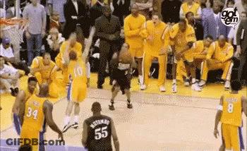 A Group Of Basketball Players Are Standing On A Court . GIF